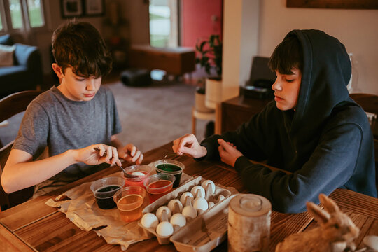 Teen Boys are Coloring Easter Eggs