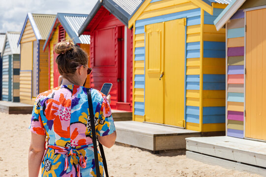 Back view of woman in Brighton Beach Bathing Boxes Australia