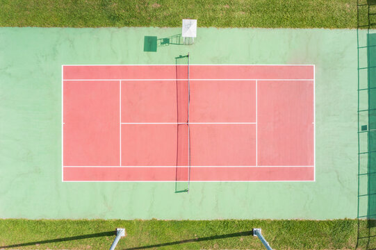 Aerial View of an Empty Tennis Court in Bright Sunlight