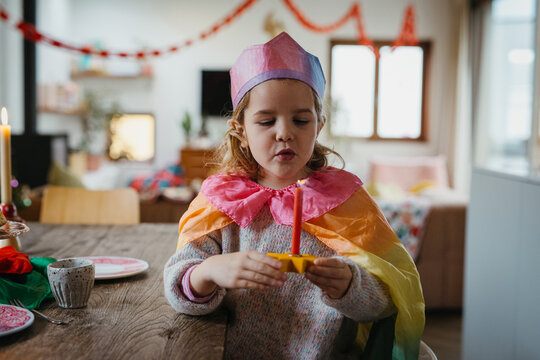 Joyful Child Enjoying Rosca de Reyes at a Decorated Table
