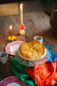 festive table setting with pie and colorful fabrics, candles lit
