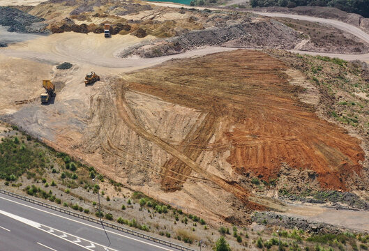 Loader leveling landfill in the field