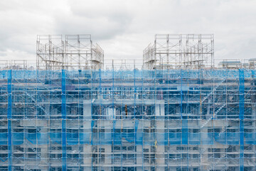 Aerial View of Blue Mesh Scaffolding at Construction Site