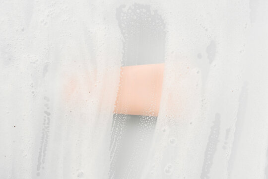 Cosmetic tube behind foam-stained glass