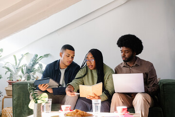 A mixed team of young professionals engages in a casual conversation