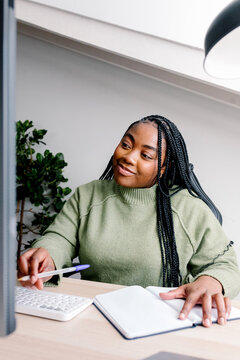 A focused remote worker sits at a desk in an elegant home office