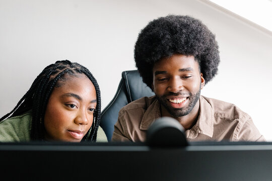 Friends enjoying a collaborative work session on a desktop computer