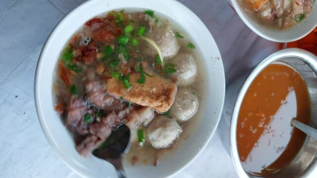 Beef meatballs, known as bakso sapi, with noodles, a popular Indonesian dish.