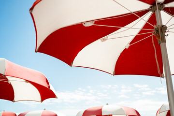 red and white umbrella on the beach on a sunny day