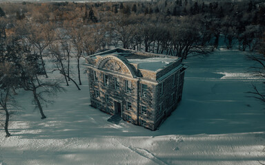 Abandoned courthouse in a snowy field