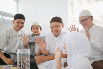 Multi Generation Muslim People Talking On Video Call With Family Members To Forgive Each Other During Eid Celebration