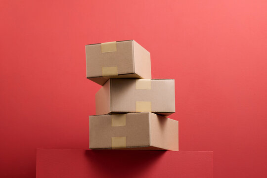 Stack of Cardboard Boxes on Red Background