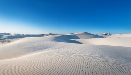 vast expanse of white sand dunes under a clear blue sky