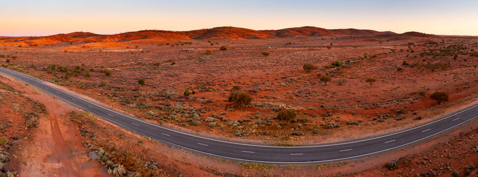 Long road stretching through barren outback landscape