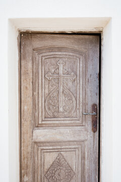 Sacred Wooden Door with Engraved Cross