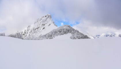 Snow-Covered mountains under a blue winter sky