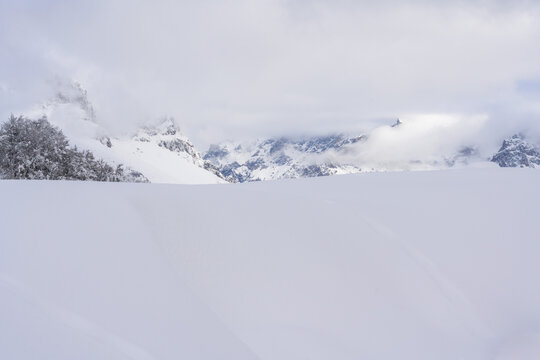Snow-Covered mountains under a blue winter sky