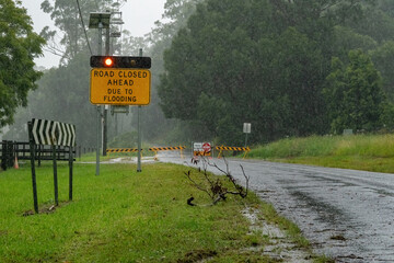 Road closed ahead sign due to the road being flooded