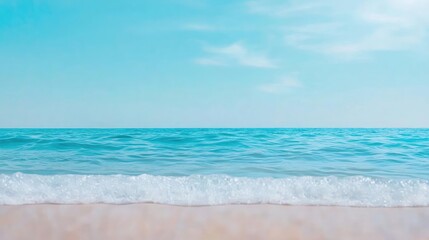 Obraz premium Seascape abstract background concept. Serene ocean view with clear blue waters and sandy beach under a bright sky.