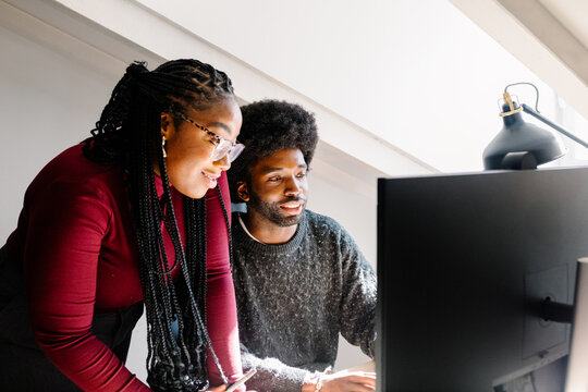 Black female supervisor gives feedback to a co-worker