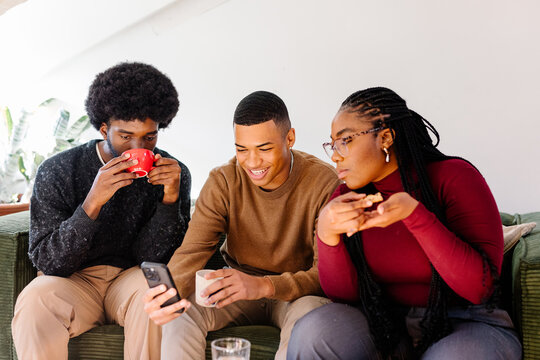 Friends enjoy some time together relaxing in their office lounge