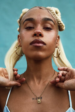 Portrait of a Woman with Blonde Braids and Necklace