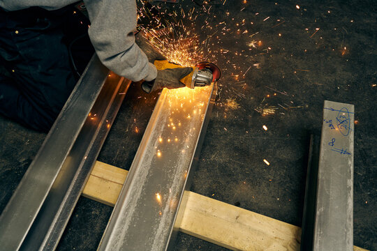 Worker Grinding Metal with Bright Sparks