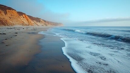 Serene Coastal Landscape Sandy Beach Ocean Waves and Cliffs at Dawn