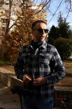 Relaxed guy leans against his bike