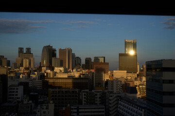 Sunset over Tokyo skyline revealing shimmering buildings and city