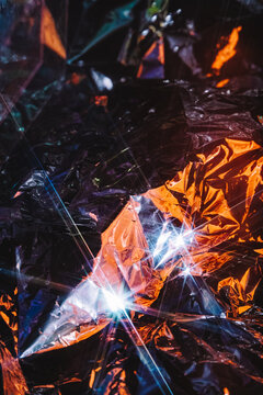 Vibrant light reflections on crumpled metal abstract art