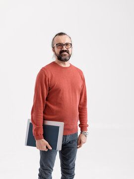 Smiling Professional Holding a Laptop Against White Background 