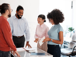 Diverse Team Collaborating and Smiling in Creative Work Environment