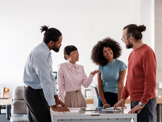 Smiling Diverse Team Collaborates in an Office Environment 