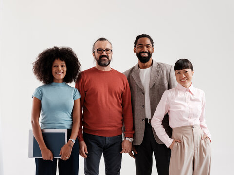 Diverse Group of Professionals Standing Together Smiling 