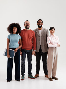 Diverse Group of Professionals Smiling Together in a Studio Setting