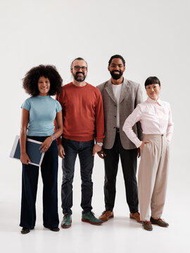 Diverse Group of Professionals Posing Together in a Studio Setting