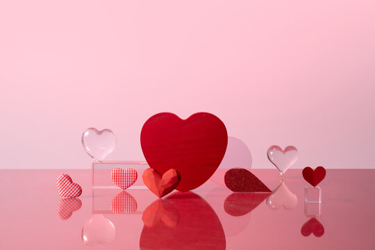 Assorted Red Hearts on Reflective Surface With Pink