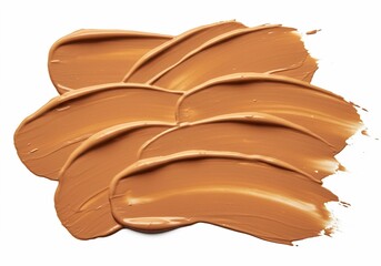 The close-up view of beige or tan cosmetic swatches with a smooth texture and curved strokes is set against a clean white background.