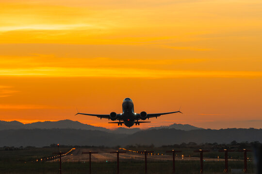 Airplane Taking Off at Vibrant Sunset