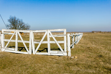 Old wooden farm gate with white paint