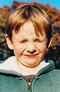 Funny film portrait of boy with scrunched up face