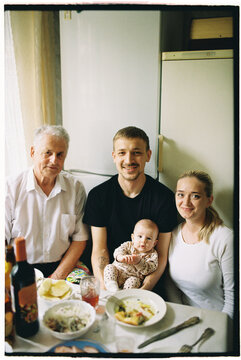 Family Enjoying a Meal at the Table Captured on Film with a Frame