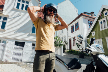 putting on his motorcycle helmet in Bergen