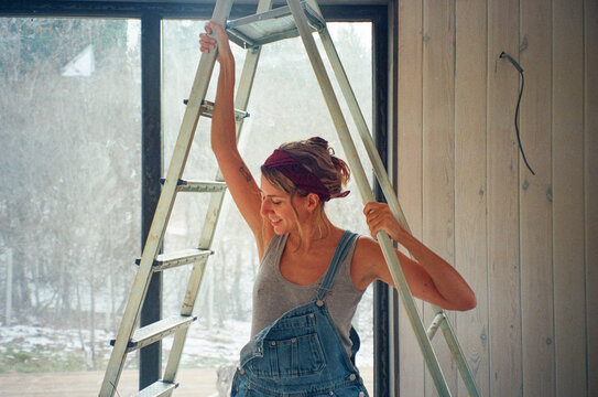 LGBTQ builder working on home repairs in a bright space