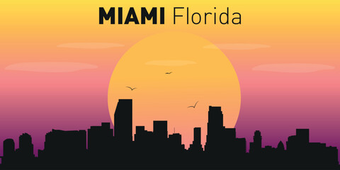 Obraz premium Silhouette of the city of Miami, Florida against the backdrop of a picturesque sunset.
