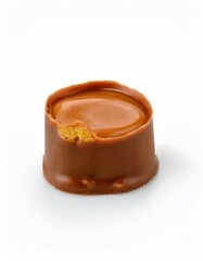 A partially eaten caramel-filled chocolate rests on a white background. The rich brown color of the chocolate contrasts beautifully with the creamy caramel center.