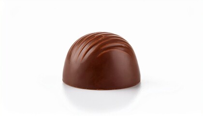 Obraz premium Single milk chocolate bonbon rests on a white background. Rich brown hues and smooth texture.
