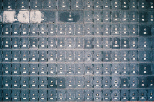 Film photography of an Abstract Wall of Mailboxes with Numbers 