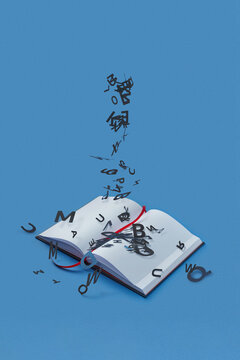 English letters escaping pages of open book